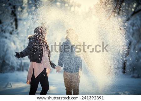 Pregnant couple playing with snow. winter Royalty-Free Stock Photo #241392391