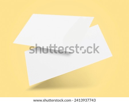 Blank business cards in air on light yellow background. Mockup for design