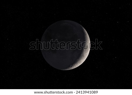 Waxing Crescent moon glowing taken November 16, 2023 above Ottawa, Canada against a starry black background.