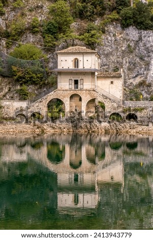 The small church called Chiesa della Madonna del Lago or The Church of the Madonna del Lago or dell'Annunziata  and it's reflection in Lake Scanno in Italy.
 Royalty-Free Stock Photo #2413943779