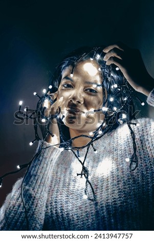 cool multiracial girl with a decorative light, photography with light, photo with decorative light near a face.