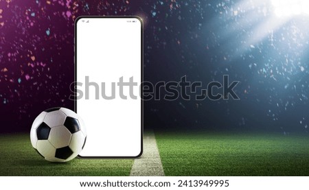 Blank smartphone and football ball on the stadium field: football championship and sports betting app
