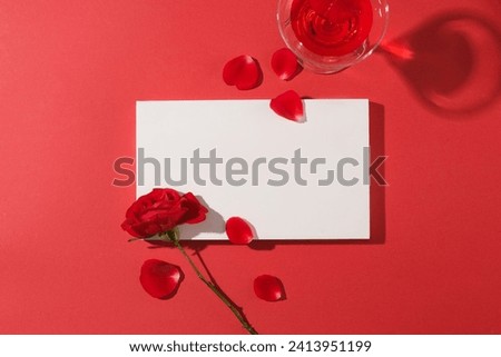 Minimal scene of a rectangle podium in white color displayed with rose and rose petals. A cocktail glass filled with red wine featured. Minimal scene with podium and abstract background