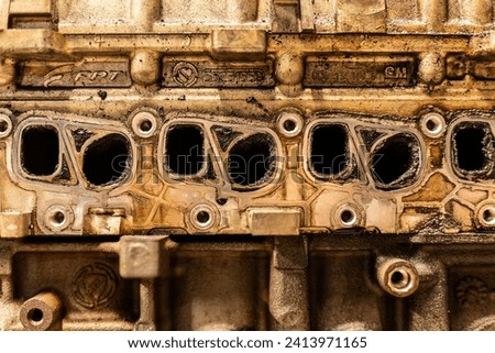 A photo showing dirty intake manifolds in a car engine, impacted by exhaust gas recirculation (EGR) effects. Royalty-Free Stock Photo #2413971165
