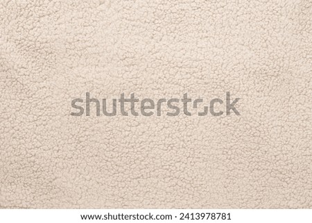 Beige cuddle teddy bear fabric as background, top view Royalty-Free Stock Photo #2413978781