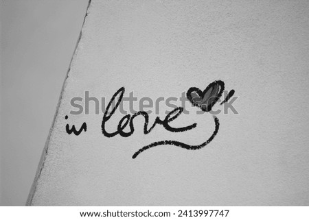 Paris Street Art. In Love Inscription with Heart on Grey Wall. Romantic Love Signs.