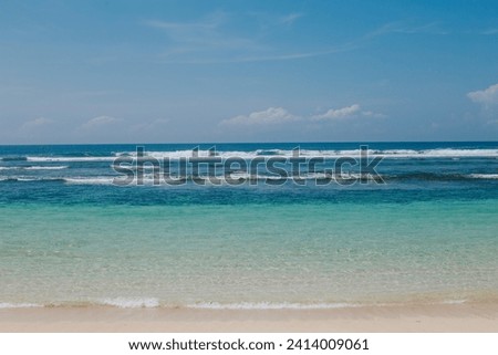 Clear blue water on white sand beach