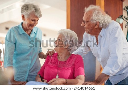 Senior woman signing a contract- friends reassuring her