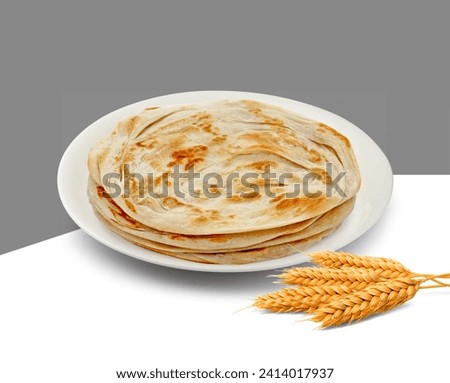 Paratha in a white plate  isolated on white background Royalty-Free Stock Photo #2414017937