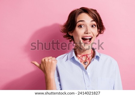Portrait of charming impressed lady open mouth direct thumb finger empty space proposition isolated on pink color background