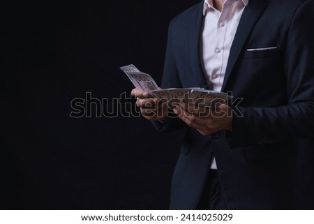 Man offers set of bills worth hundred dollars. Hands close up. Venality, bribe, corruption concept. Hand giving money. Hand receives money from businessman. Royalty-Free Stock Photo #2414025029