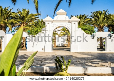 Picturesque whitewashed architecture with green elements in Costa Teguise, Lanzarote, Canary Islands Royalty-Free Stock Photo #2414025375