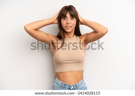 hispanic pretty woman feeling stressed, worried, anxious or scared, with hands on head, panicking at mistake Royalty-Free Stock Photo #2414028115