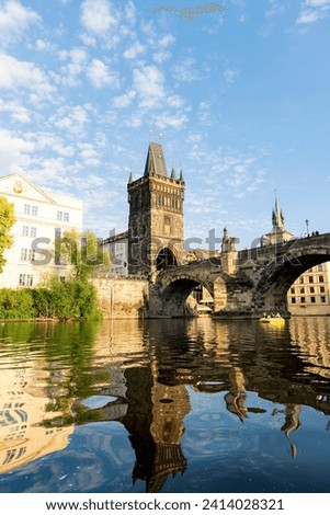 Photograph taken in Prague, Czech Republic, offering a view from the Moldava River, showcasing the bridge and monuments