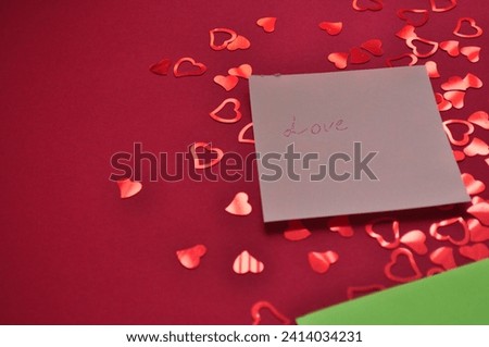 love write on the pink paper on thered background with hearts - valentines day background 