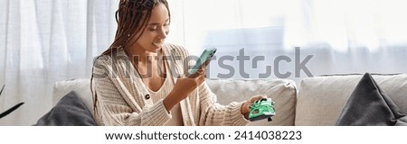 beautiful joyous african american woman with braces taking photo of her new green shoes, banner