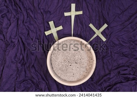 Three palm crosses and ash on purple background. Ash Wednesday concept.