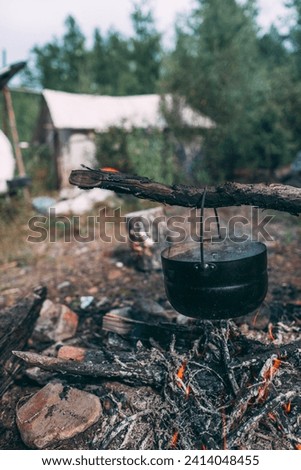 Cauldron over camp fire stock photo