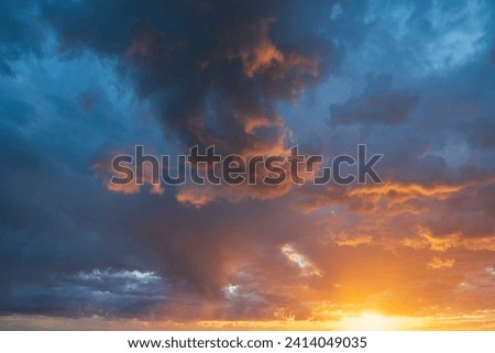 Glowing real sky at sunset texture background overlay. Dramatic red, orange, and purple clouds. High resolution photography perfect for sky replacement