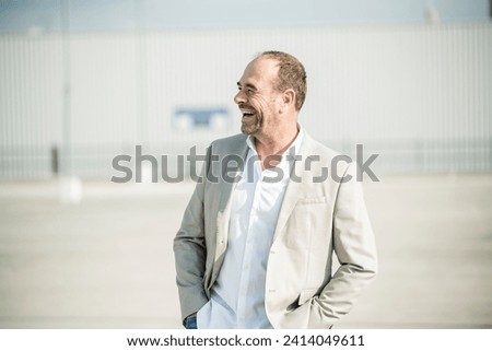 Laughing mature businessman outdoors stock photo