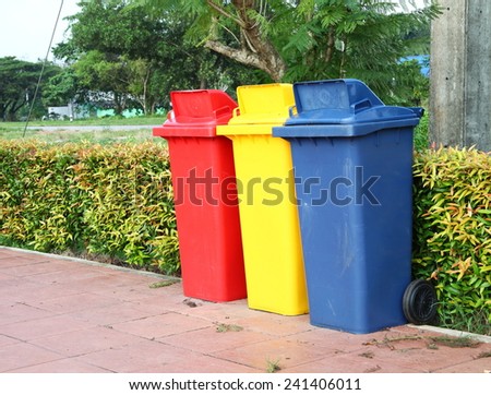 Large size of plastic garbage container put on the footpath floor among daytime natural light represent the garbage recycle related idea.
