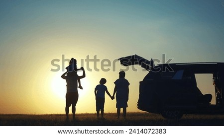 family traveling by car. family watching sunset silhouette next to the car in the park. happy family kid dream concept. people in the park. family car camping resting in nature lifestyle