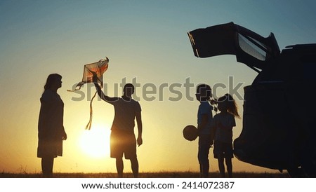 family traveling by car. family watching sunset silhouette next to the car in the park. family playing kite ball. people in the lifestyle park. family car camping resting in nature