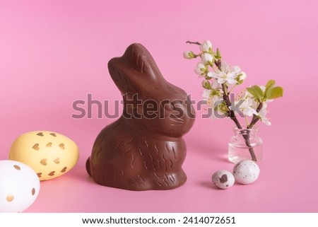 Chocolate rabbit symbol Easter holidays on a pink background. Easter hunt concept. Royalty-Free Stock Photo #2414072651