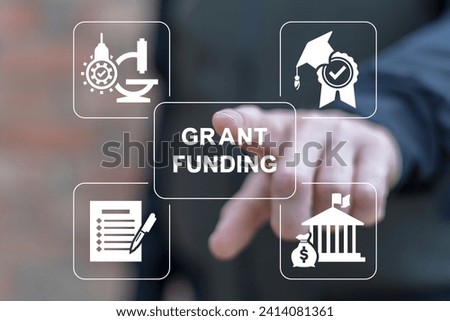 Man using virtual touchscreen presses inscription: GRANT FUNDING. Concept of business, education grants funding. Innovation Grant Fund Application Donation. Royalty-Free Stock Photo #2414081361