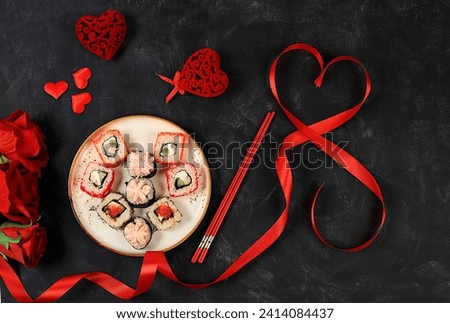 Heart made of fresh sushi rolls with roses, Valentine's Day food, traditional Japanese cuisine, banner for advertising or bar invitation, menu, space for text, top view, selective focus Royalty-Free Stock Photo #2414084437