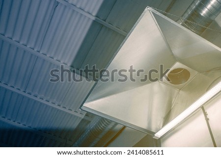 exhaust hood in a large production facility in harsh conditions of harmful gases and dust, close-up Royalty-Free Stock Photo #2414085611