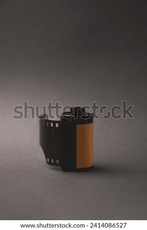 35mm film roll on gray background