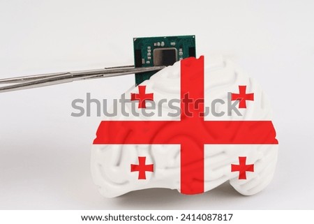 On a white background, a model of the brain with a picture of a flag - Georgia, a microcircuit, a processor, is implanted into it. Close-up