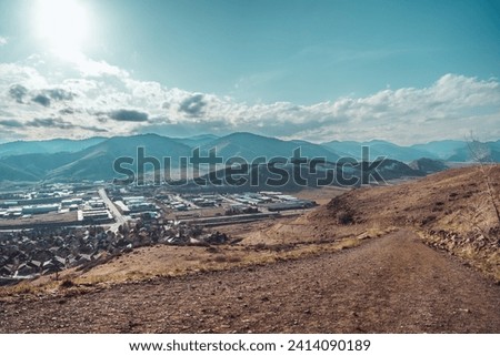 A photo of Golden, CO as viewed from a hill, during a hike. The mountain range pictured is known as the Rocky Mountains.