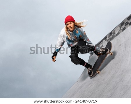 Germany- baden-wurttemberg- waiblingen- young woman skateboarding in skate park Royalty-Free Stock Photo #2414090719