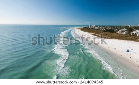 Drone Fly view over beach in Siesta Key,  Florida. Beautiful Siesta Key beach on a sunny day. Turquoise transparent water and blue sea in Siesta Key beach.