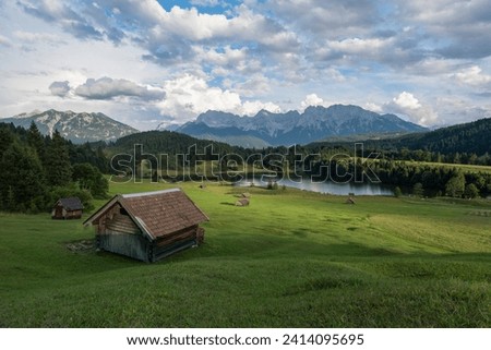 Germany- bavaria- werdenfelser land- lake geroldsee with hay barn- in background the karwendel mountains Royalty-Free Stock Photo #2414095695