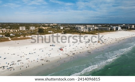 Beautiful Siesta Key beach on a sunny day. Drone Fly view over beach in Siesta Key,  Florida. Turquoise transparent water and blue sea in Siesta Key beach.
