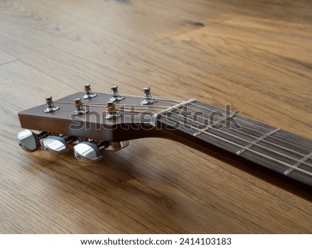 Guitar headstock with tuners. Perspective view. Royalty-Free Stock Photo #2414103183