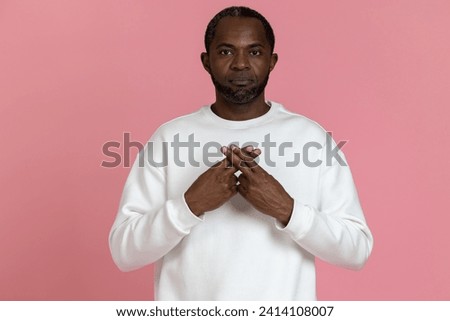 Deaf mute black man wearing white sweatshirt gesturing sign language Royalty-Free Stock Photo #2414108007