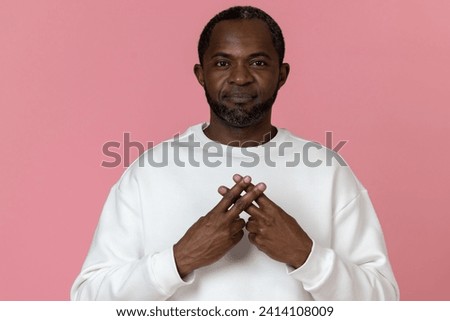 Black man wearing white sweatshirt using sign language Royalty-Free Stock Photo #2414108009