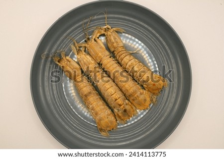 Fresh mantis shrimp on a plate, closeup of photo. Royalty-Free Stock Photo #2414113775