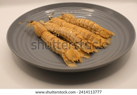 Fresh mantis shrimp on a plate, closeup of photo. Royalty-Free Stock Photo #2414113777