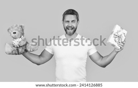 surprised man with present for valentine day. photo of man holding valentine present