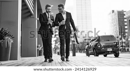 businessmen walk with phone in suit, copy space advertisement. photo of businessmen walk Royalty-Free Stock Photo #2414126929