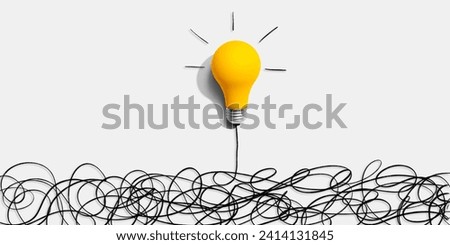 Clarifying complex ideas theme with light bulb - Flat lay Royalty-Free Stock Photo #2414131845