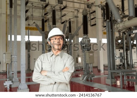Engineers technicians man wearing professional helmets working in powerhouse or power plant. Royalty-Free Stock Photo #2414136767