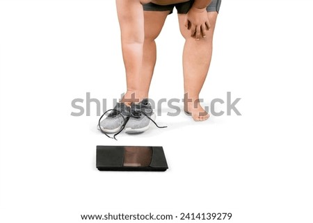 Picture of an overweight man checking his weight