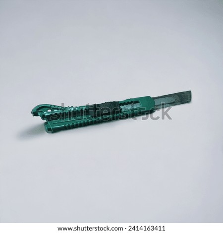 green cutter or sharp knife and white background