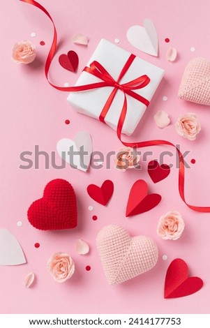 Gift or present box for Saint Valentine day or Mother day decorated with pink red hearts and roses flowers top view. Flat lay festive greeting card.
 Royalty-Free Stock Photo #2414177753